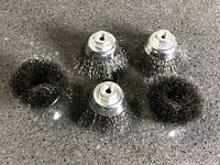 five wire brushes on countertop