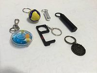 Overview of six keychains arranged on surface