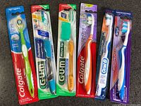 Front view of all six sealed toothbrushes