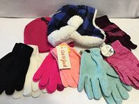 All items grouped: two hats and six glove pairs