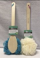 Front view of both EcoTools bamboo bath brushes showing mesh poufs (blue and ivory) and retail hang tags