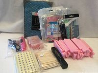 Group shot of all nail care items including VAGA package, LiBiuty kit, nail dryer, separators, stickers, cuticle sticks, nail file, buffers, artificial tips