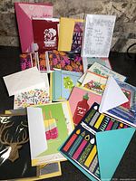 overview of assorted cards and envelopes spread on countertop