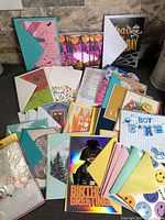 Spread of assorted greeting cards and envelopes