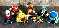 Group shot of seven Tech Deck Dudes on fingerboards