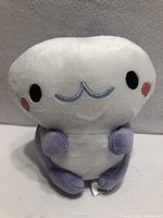 Front view of plush showing facial features and coloration