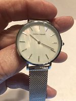 Front view showing dial, branding and index markers