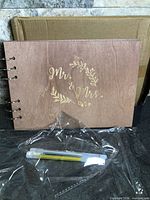 Front cover showing engraving, rings, pens, box