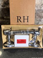 Boxed Restoration Hardware Lugarno chrome toilet paper holder with mounting hardware visible
