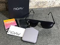 All contents laid out: sunglasses, case, pouch, booklet, box