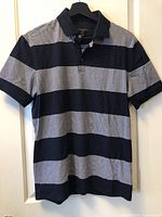 Front view of navy and white stripe RW & Co. polo shirt on hanger