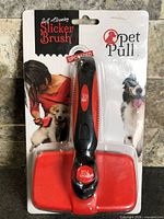 Front of sealed package showing Pet Pull self-cleaning slicker brush