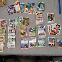 Wide view of assorted baseball cards spread out on surface