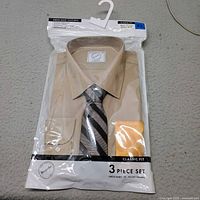 Front of sealed package showing shirt, tie, pocket square and Bespoke branding