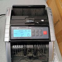 Front view of bill counter with display and controls