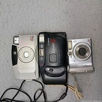 Front view of all three Canon cameras—Sure Shot, Snappy AF and PowerShot A530