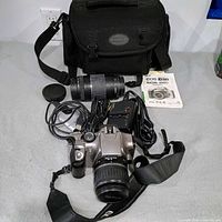 Overall kit: camera body with 18-55 mm lens, telephoto lens, bag, charger, cords, lens cap, manual