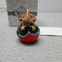 Mouse figurine on ornament with box and card visible