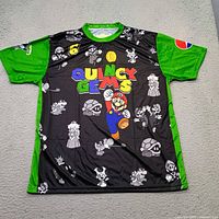 Front view of jersey showing Super Mario graphics, Quincy Gems text, number 6, and green sleeves.