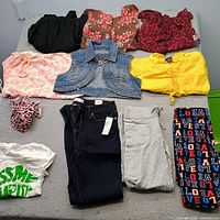 All eleven garments laid out on bed for overview