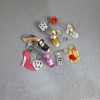 Overview of all 11 keychains on grey surface