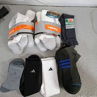 Full lot view showing two Head 6-pair packs, Interwoven grey socks, and three Adidas pairs