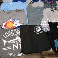Spread showing multiple graphic tees including Long Beach Island, blueshirts hockey, athletic tops