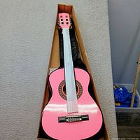 Guitar in box with neck and body wrap, soft case visible