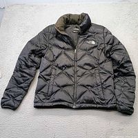 Front view of black The North Face quilted jacket
