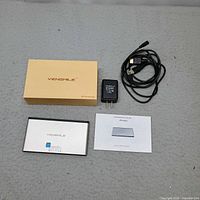 Full lot view showing mini PC, power adapter, HDMI cable, manual and box