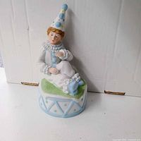 Front view of porcelain boy clown music box