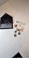 Overview of earrings on card, jewellery pouch, rings, brooch, pendants, key ring