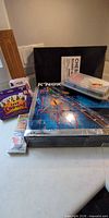All items grouped: K'NEX boxed set, cribbage board, poker chip case, two card game boxes, chess board case