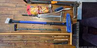 Overview of all long-handled tools, fishing rods, broom, rake, tow rope