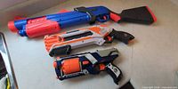 All three Nerf blasters laid out side by side