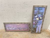 Both framed prints leaning against wall showing size and matching frames