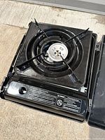 Top view of portable camp stove with burner and pan support in place