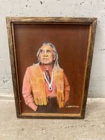 Front view of framed painting showing subject, signature, frame