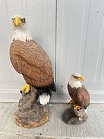 Front view of both eagle figurines displaying size difference and details