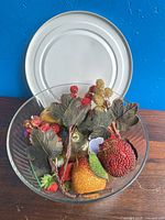 Overall lot showing glass bowl filled with artificial fruit and berries