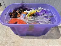 Purple tote containing assorted Halloween decorations