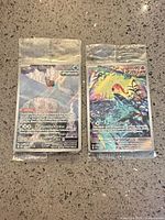 Front view of both sealed foil promo cards