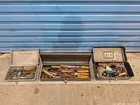 Overview of three open toolboxes with contents