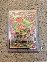 Front view of Rayquaza VMAX Pokémon TCG card in sleeve and top-loader