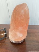 Front view of Himalayan salt lamp on wooden surface