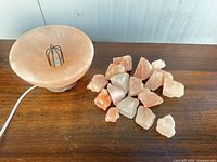 Lamp bowl and group of salt rocks displayed on wooden surface