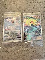 Front of both sealed promo cards Scream Tail and Iron Bundle