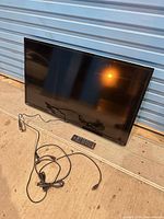 Front view of 39-inch Toshiba TV with remote and power cord