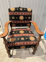 Front view of wood armchair showing upholstery pattern and frame