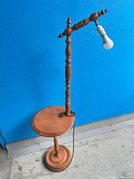 Full view of wood floor lamp with integrated table and bulb